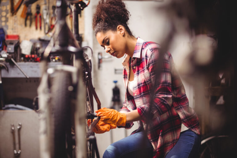 Mechanic repairing a bicycle in workshop
