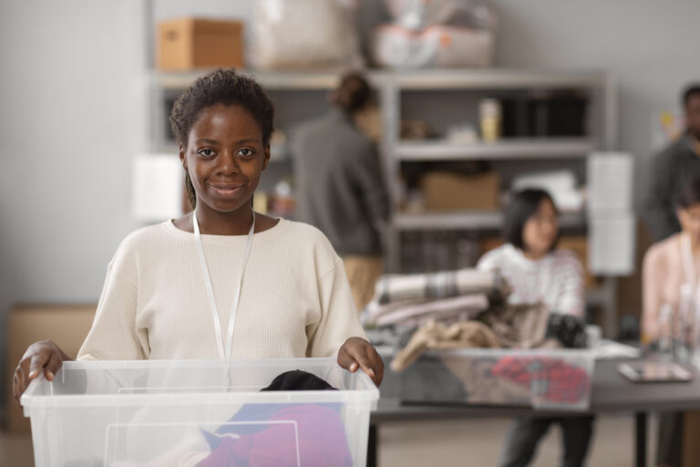 volunteer-selecting-organizing-clothes-donations-charity
